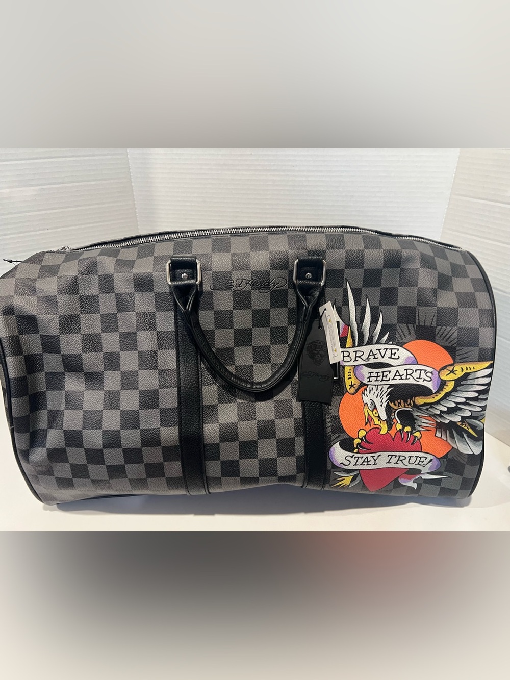 Ed Hardy duffel bag features a black and grey checkered pattern